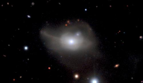 This image from the MUSE instrument on ESO's Very Large Telescope shows the active galaxy Markarian 1018, which has a supermassive black hole at its core. The faint loops of light around the galaxy are a result of its interaction and merger with another galaxy in the recent past. (Image by ESO/CARS survey)