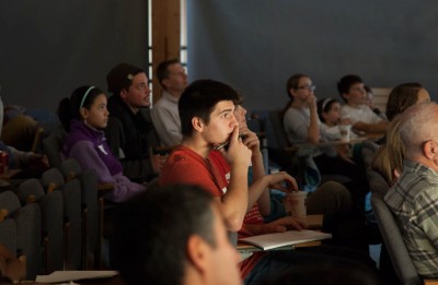 A student listens intently at the last Science Café in November. (Photo courtesy of Open Labs)